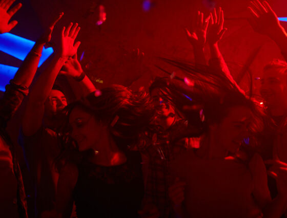 Carefree young people having fun in night club